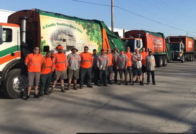 Employees standing in front of Flood Brothers trucks
