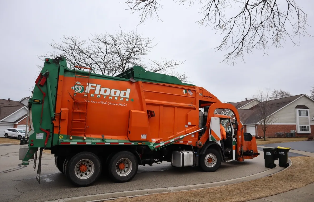 Flood Brothers residential truck in a neighborhood