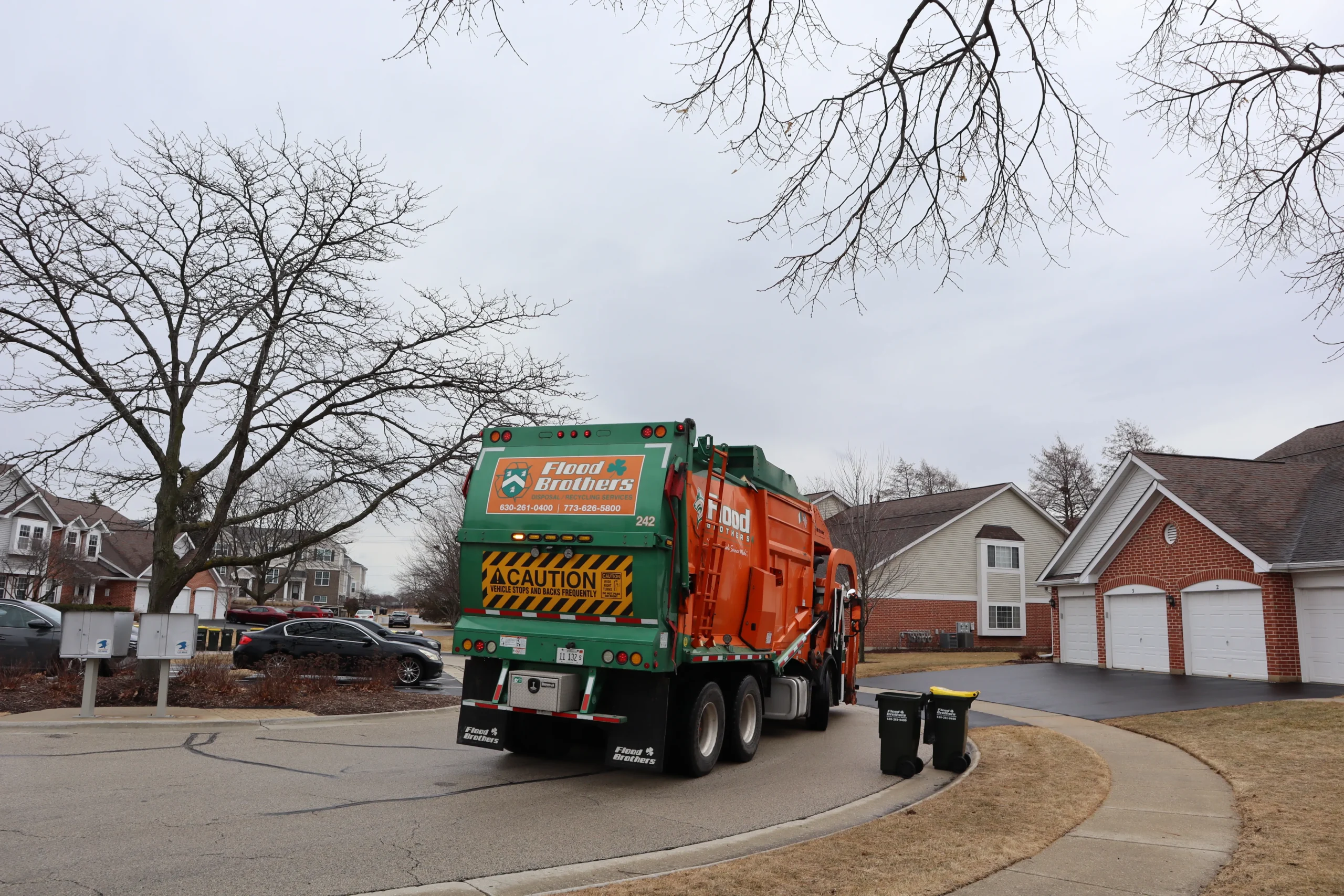 Flood Brothers residential truck in a neighborhood