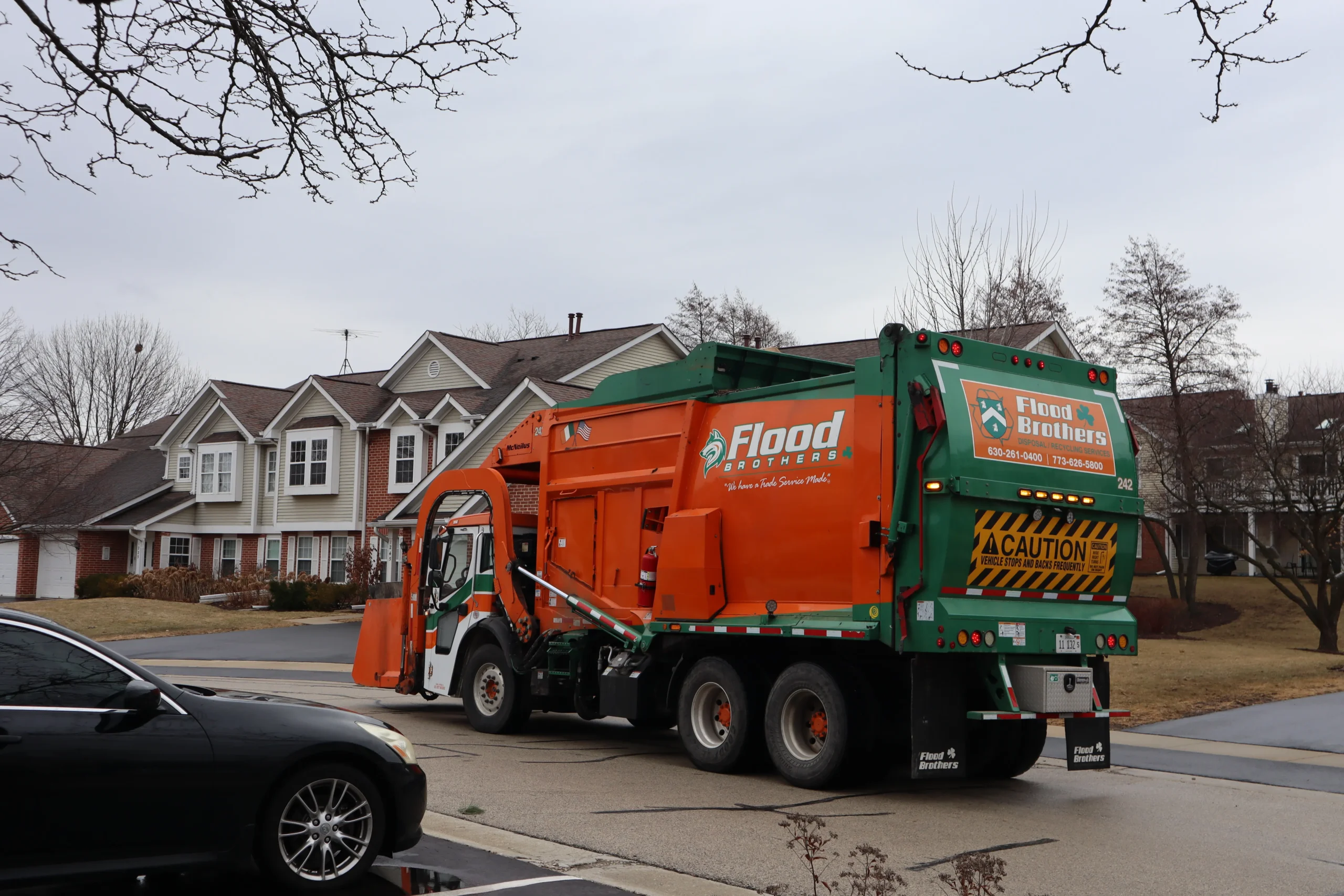 Flood Brothers residential truck in a neighborhood