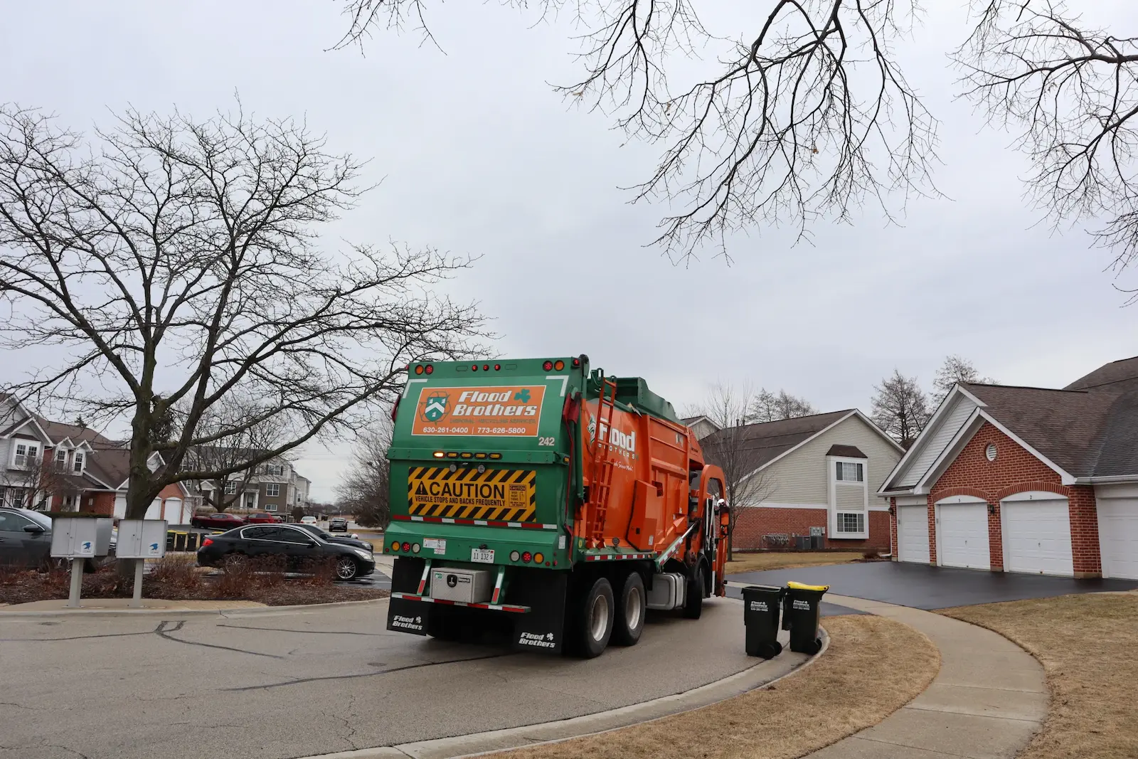 Flood Brothers residential truck in a neighborhood